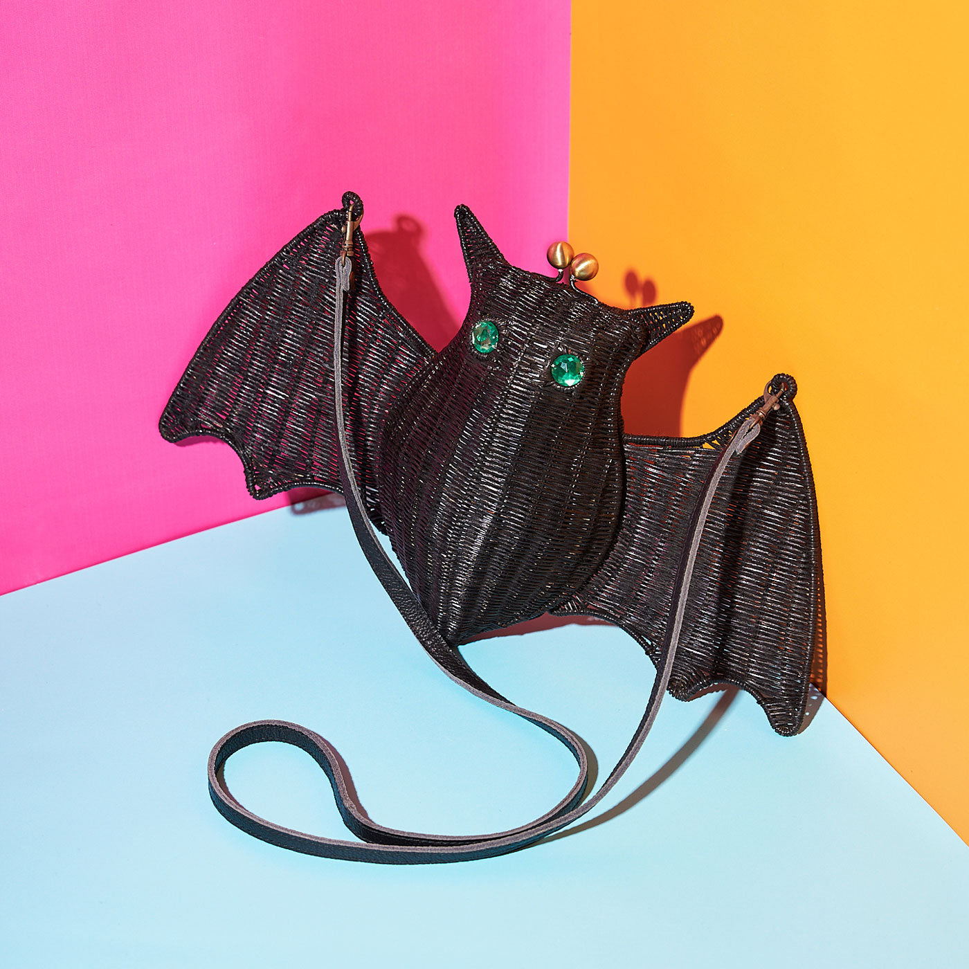 Wicker Darling's Batholomew the green-eyed bat purse on a colourful background