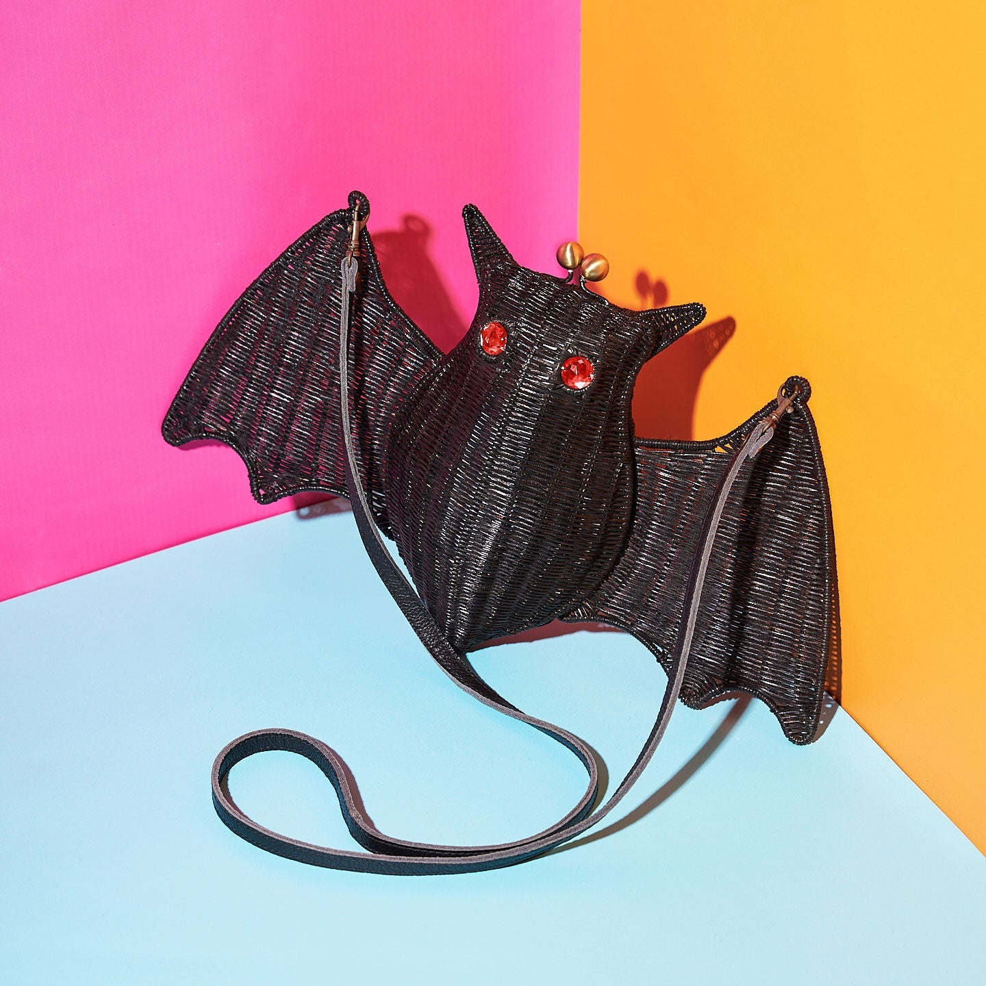Wicker Darling's Battie Page the bat purse on a vibrant background