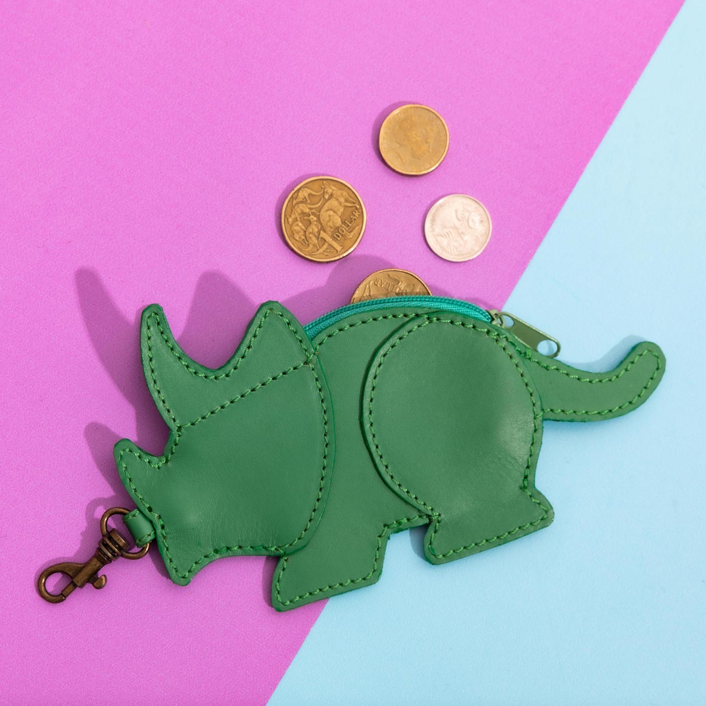 Wicker Darling's Benedict the triceratops mini coin purse on a colourful background