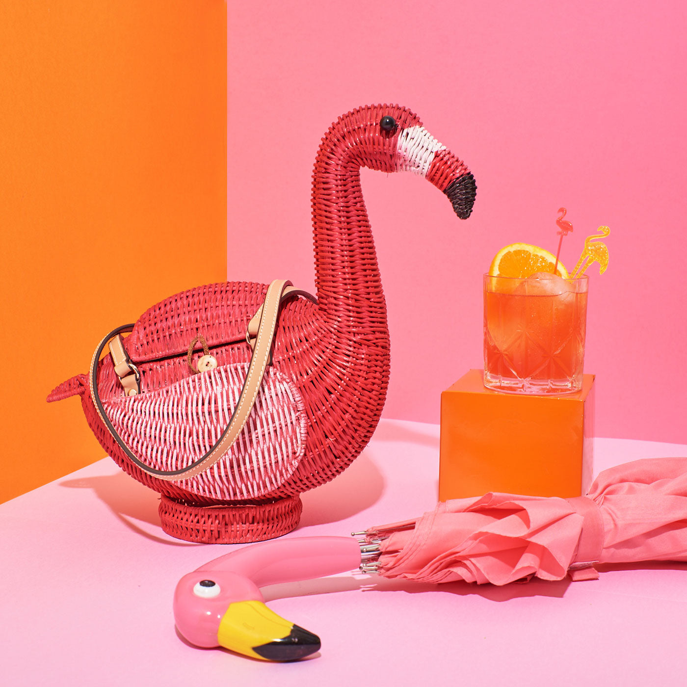 Wicker Darling's Flamingo (Monty!) Montoya Flamingo Handbag on a colourful background