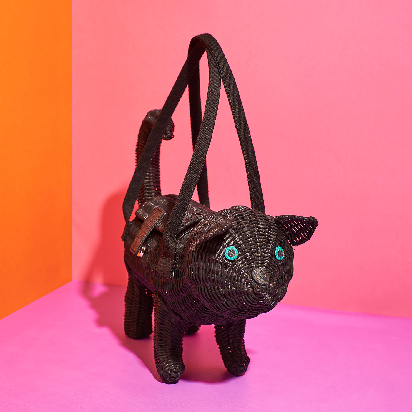 Wicker Darling's Vince the black cat handbag on a vibrant background