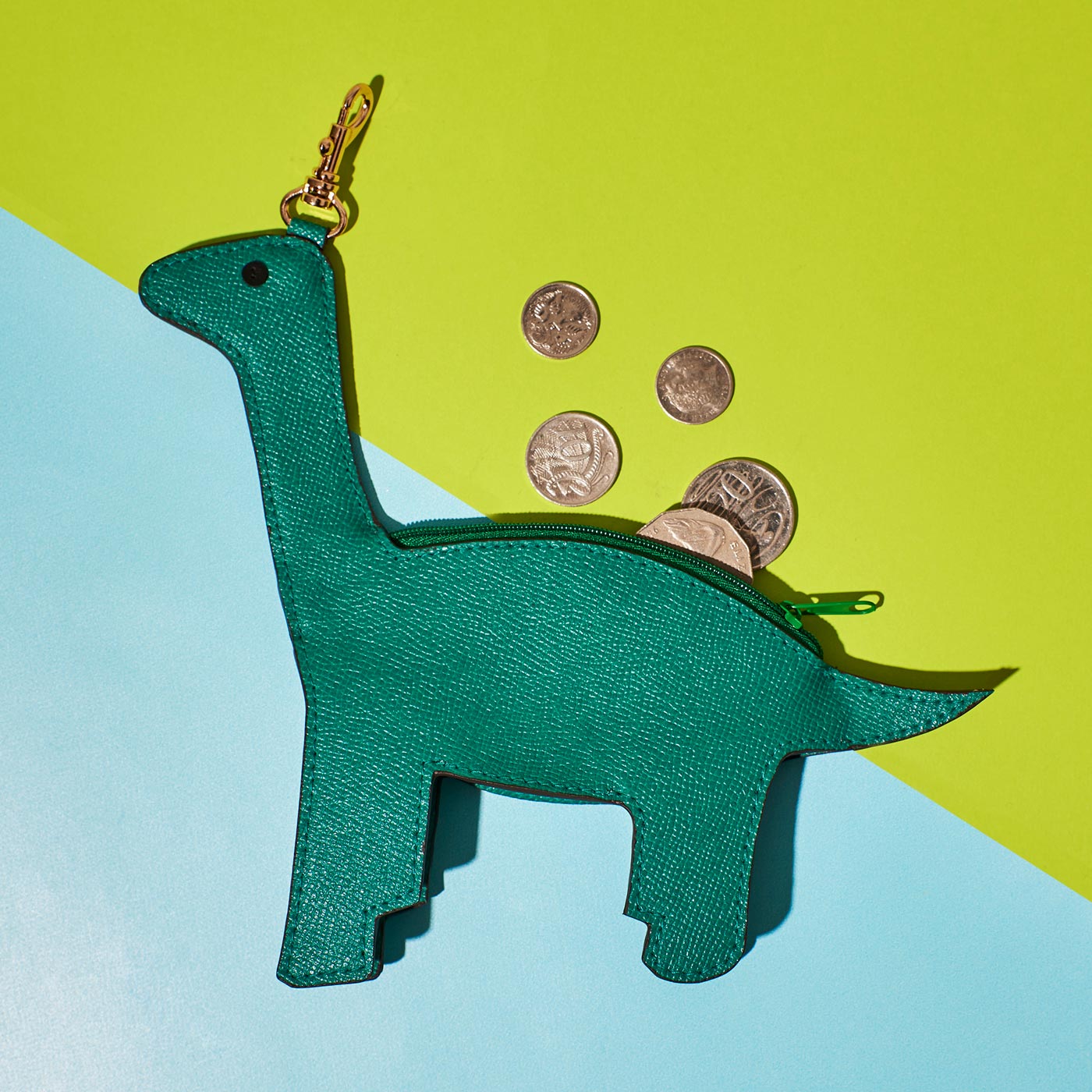 Wicker Darling's Branwell the brontosaurus coin purse on a colourful background
