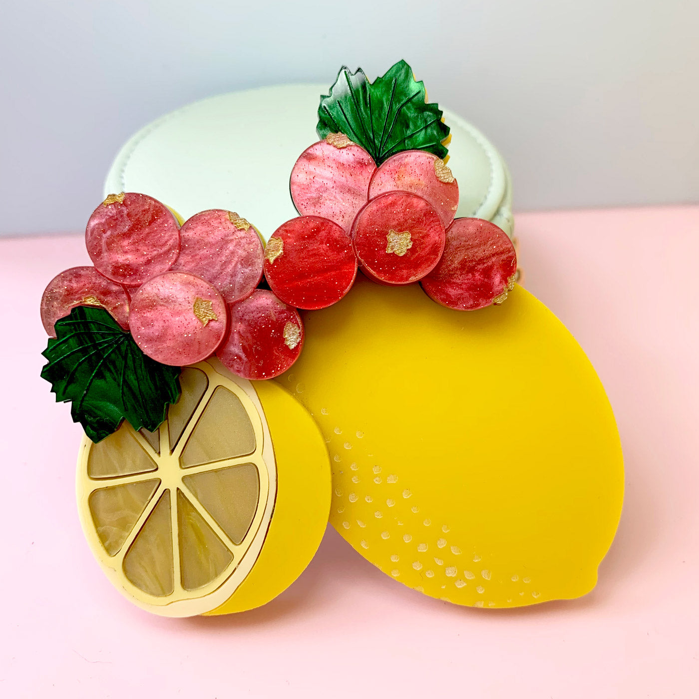 Wicker Darling's Limoncello the lemon brooch on a colourful background