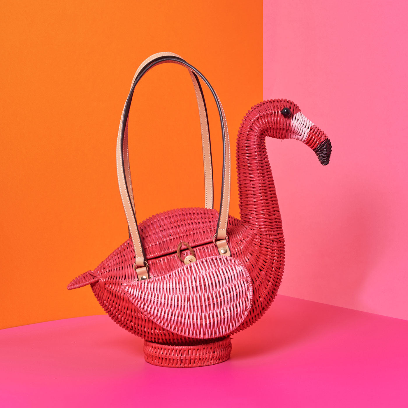 Wicker Darling's Flamingo Montoya the flamingo purse on a colourful background