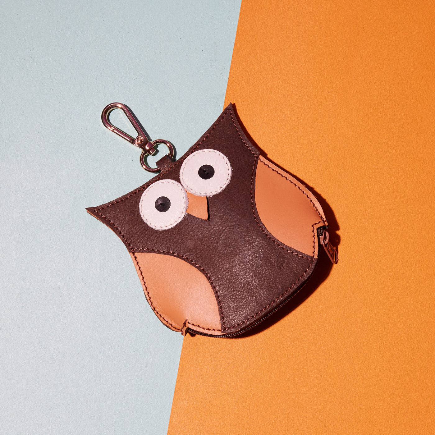 Wicker Darling's Arianrhod the owl coin purse on a colourful background