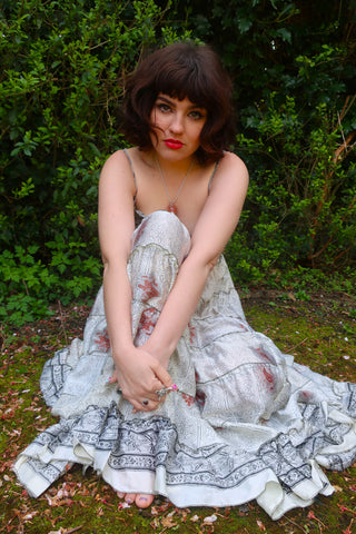 photo of model wearing white floral pattern Delilah tiered elasticated maxi dress by all about audrey