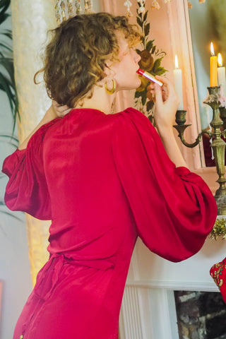 model wears lola balloon sleeve maxi dress in ruby red christmas edit gift ideas by all about audrey