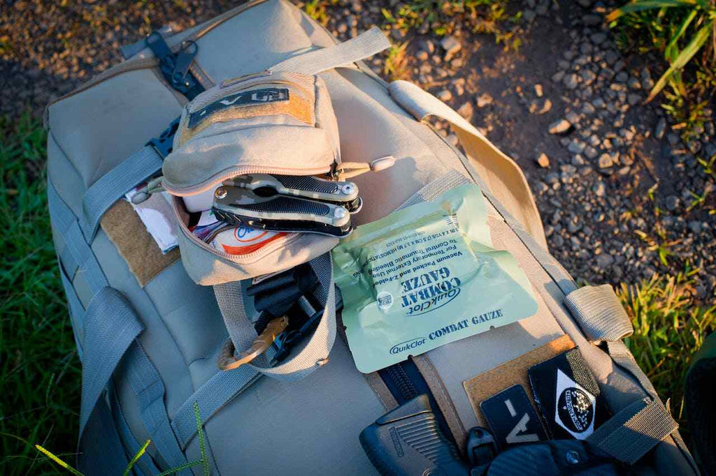 survival backpack sitting on the ground outdoors