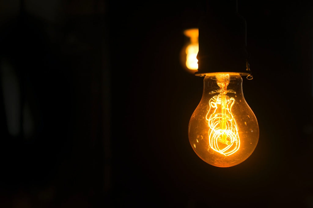 yellow light bulb in a dark room