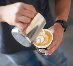 Pooring an Ikon Coffee latte is an art
