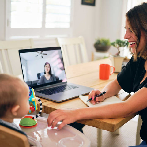 busy mom with baby and laptop