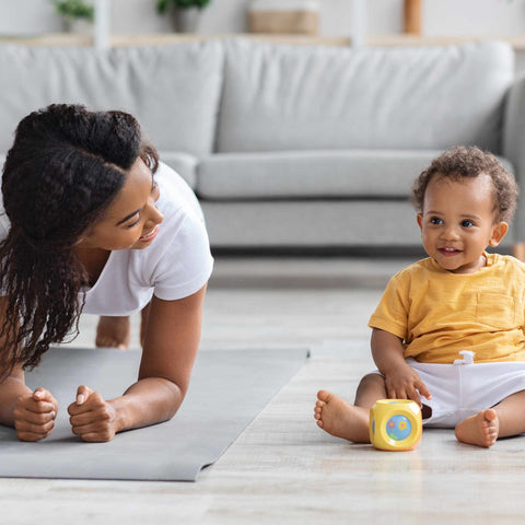 mommy and baby exercising on floor