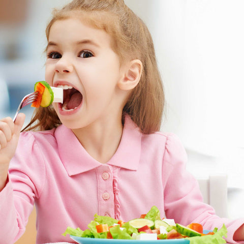 kid eating salad