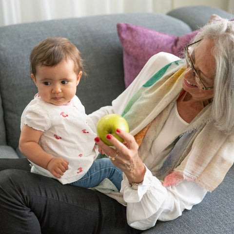 grandma holding and playing with toddler