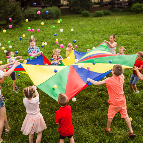 kids playing with a parachute