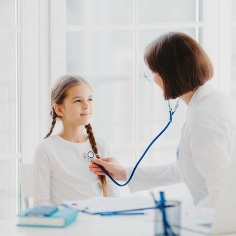 kid getting check up at pediatrician's office