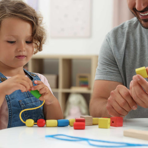 dad and daughter playing with blocks
