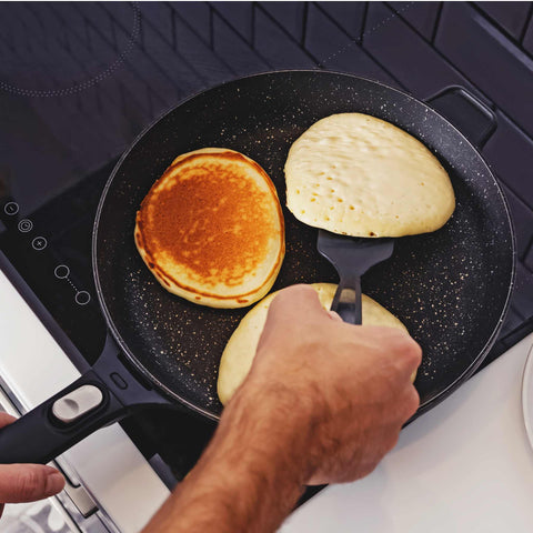 cooking pancakes on the stove