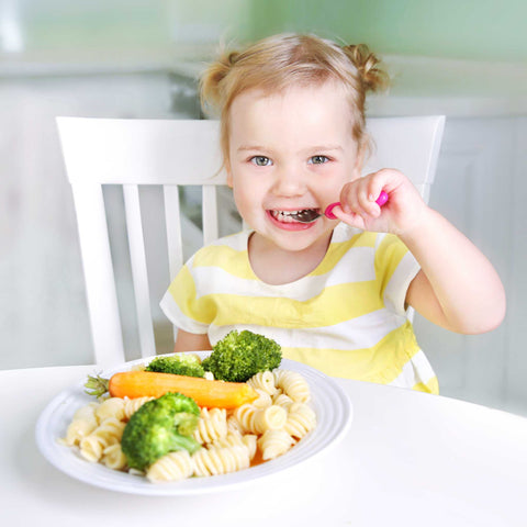 girl eating pasta and broccoli