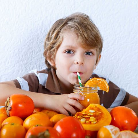 kid drinking orange smoothie