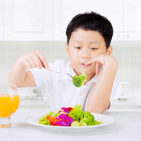 kid eating vegetables