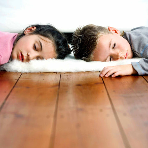 two kids sleeping on the floor