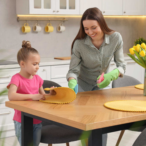 mom and daughter wiping the table