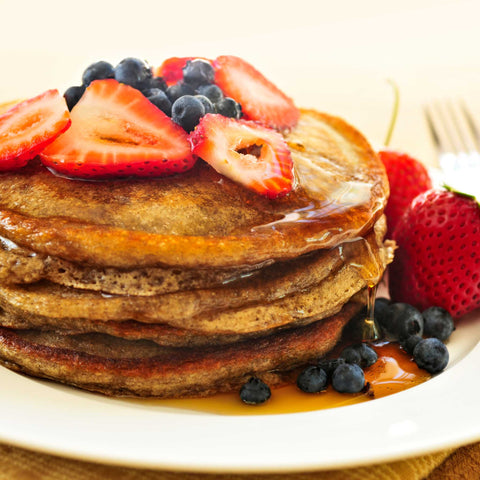 stack of pancakes with strawberries and blueberries