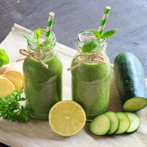 green smoothies in jars with cucumber and lime