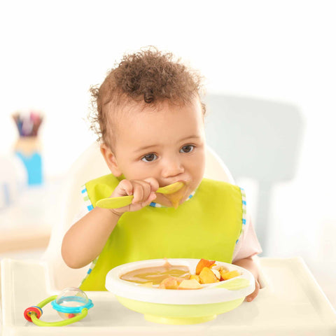 baby eating in high chair