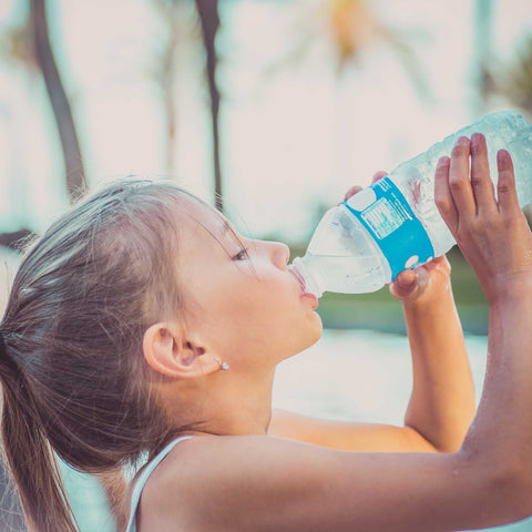 girl drinking from a water bottle
