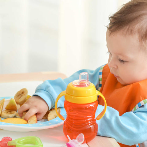 toddler eating healthy fruit with hands