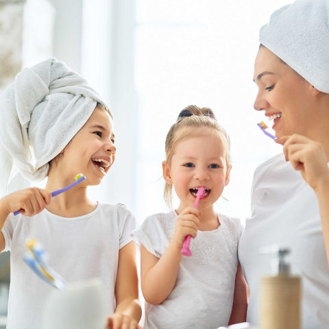 mom and kids brushing teeth