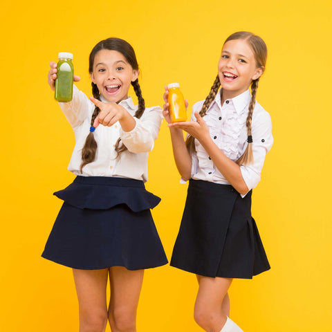 kids with bottles of smoothies