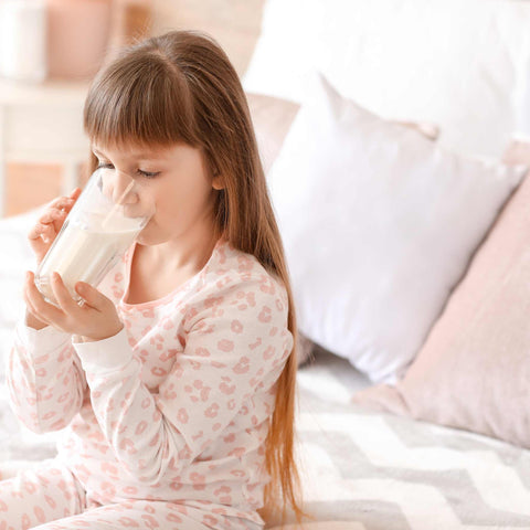 girl drinking a glass of milk