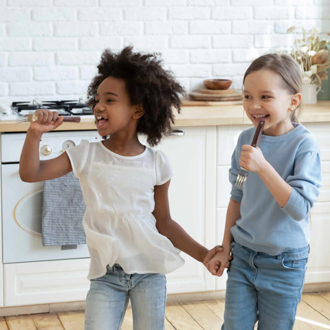 kids laughing and singing into forks