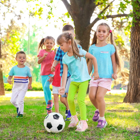 kids playing with soccer ball in park