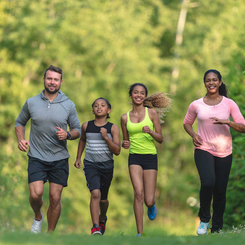 family running through the grass