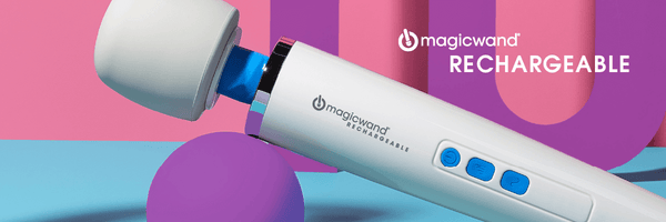 Header image of the Magic Wand Rechargeable. The massager is tilted upwards while the handle balances on a purple ball. The text "Magic Wand Rechargeable" is clearly visible on the handle of the massager.  | Kinkly Shop