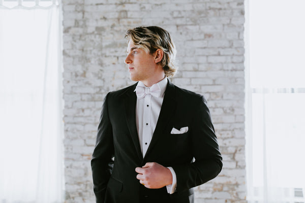 Groom wearing a black tuxedo from Generation Tux.