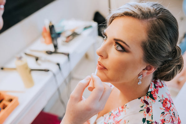 getting ready for wedding with makeup and robe