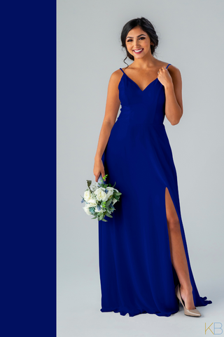 Model in Kennedy Blue Bridesmaid Dress "Sophie" in 'Royal Blue'. Elegant dress with a romantic v-neckline and long skirt with a side slit.
