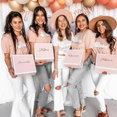 Bride and Bridesmaids holding their personalized bridesmaid proposal gift box.
