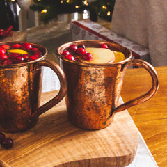 Copper Moscow Mule Mugs in a christmas setting