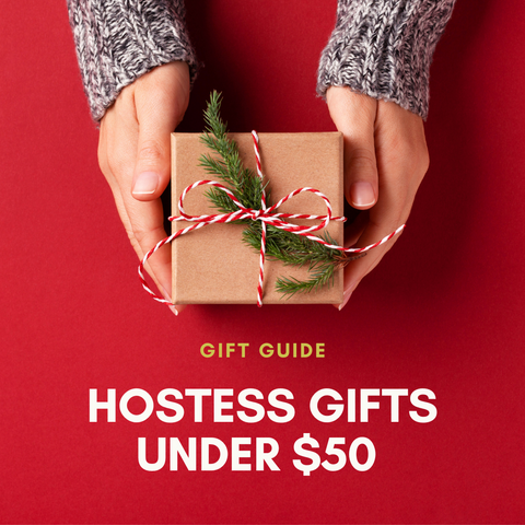 Hands handing a wrapped gift on a red background with the words "Gift Guide - Hostess Gifts Under $50"