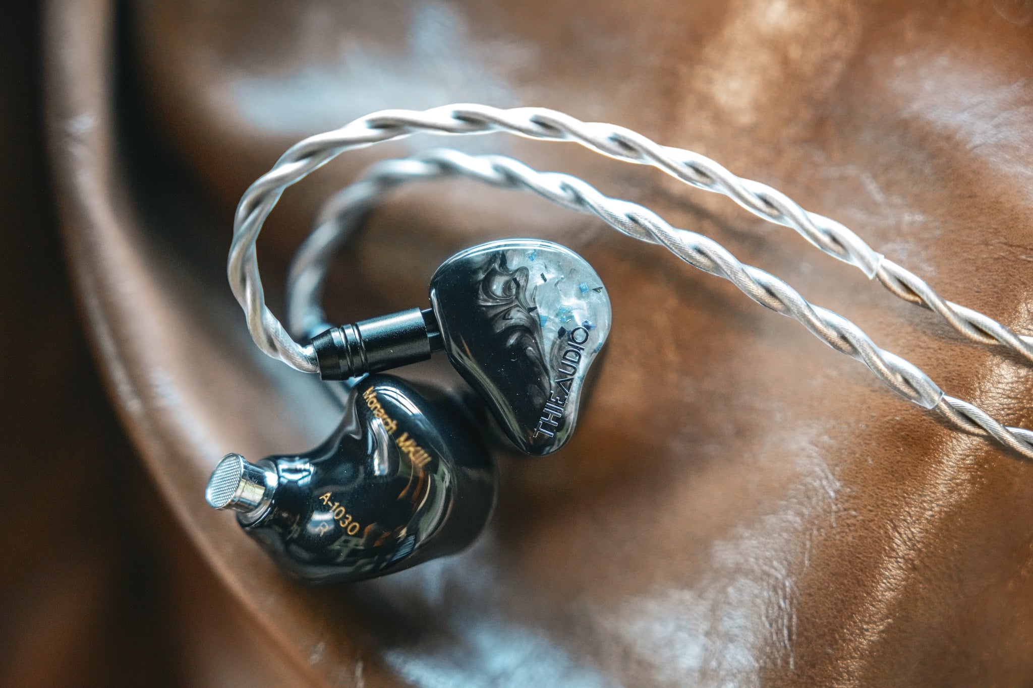 ThieAudio Monarch MKIII resting on a leather couch from the Bloom Audio gallery