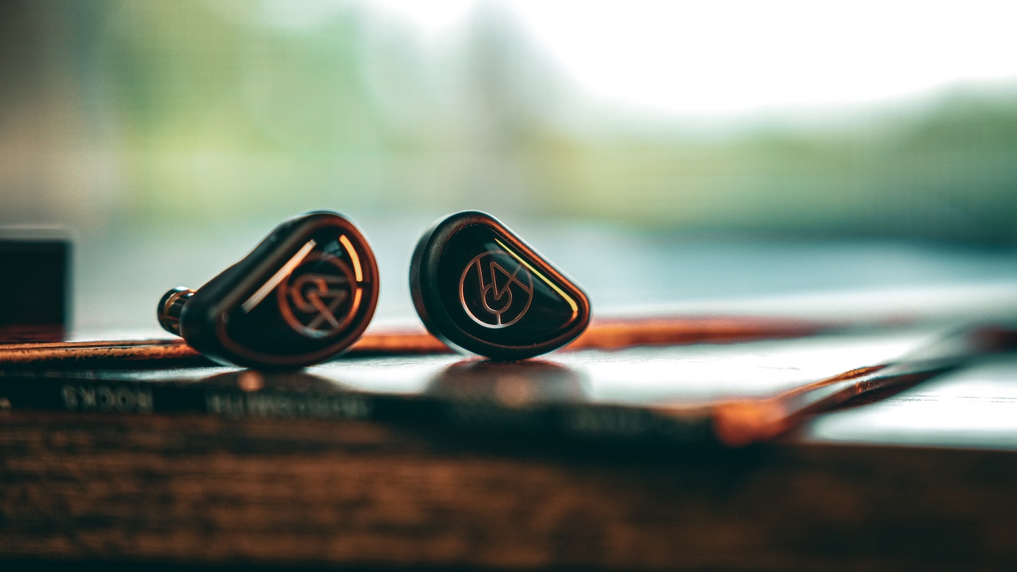 64 Audio Aspire 4 resting on a vinyl record on top of a wooden desk