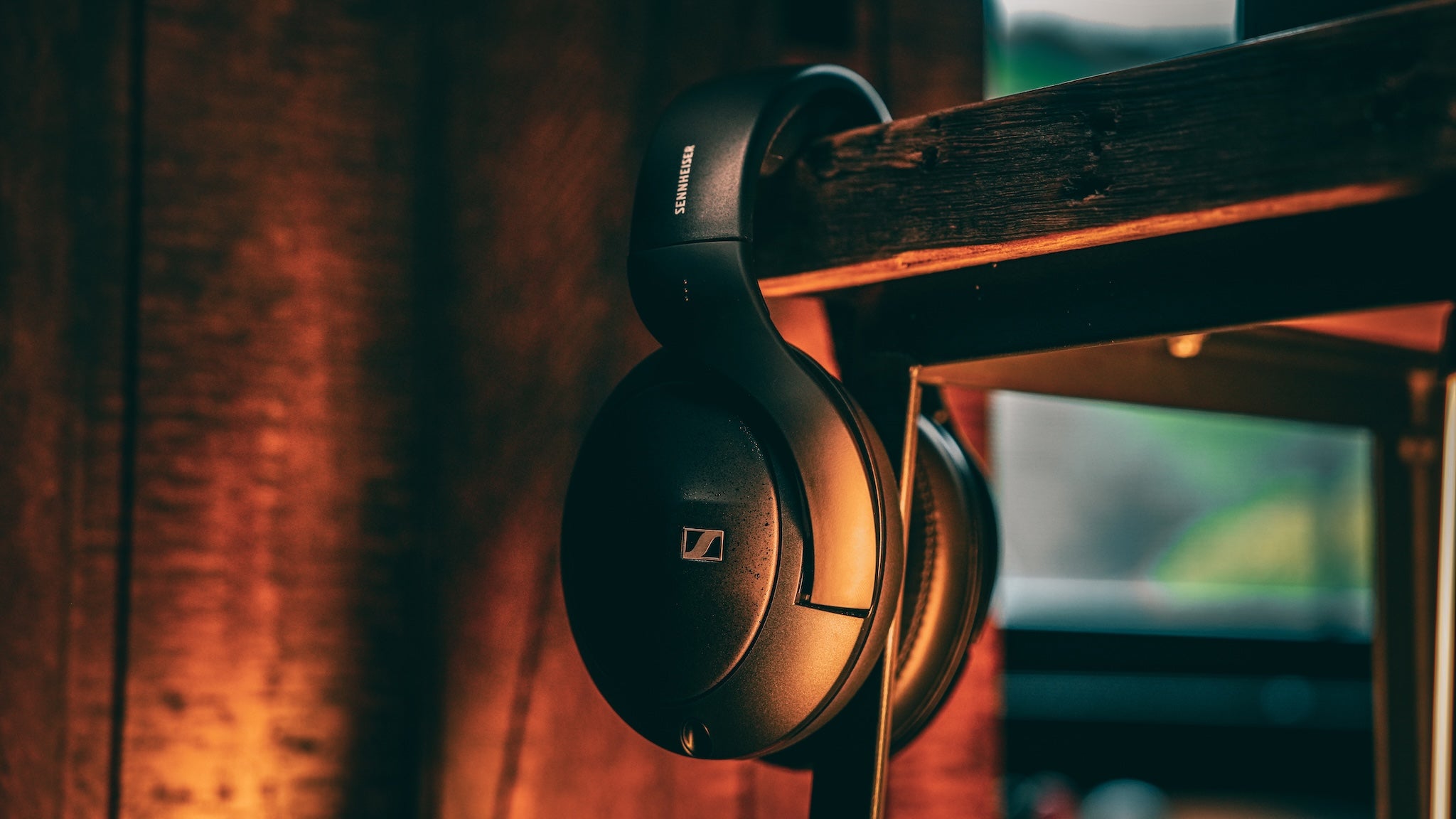 Sennheiser 620S hanging off the corner of a wooden stool