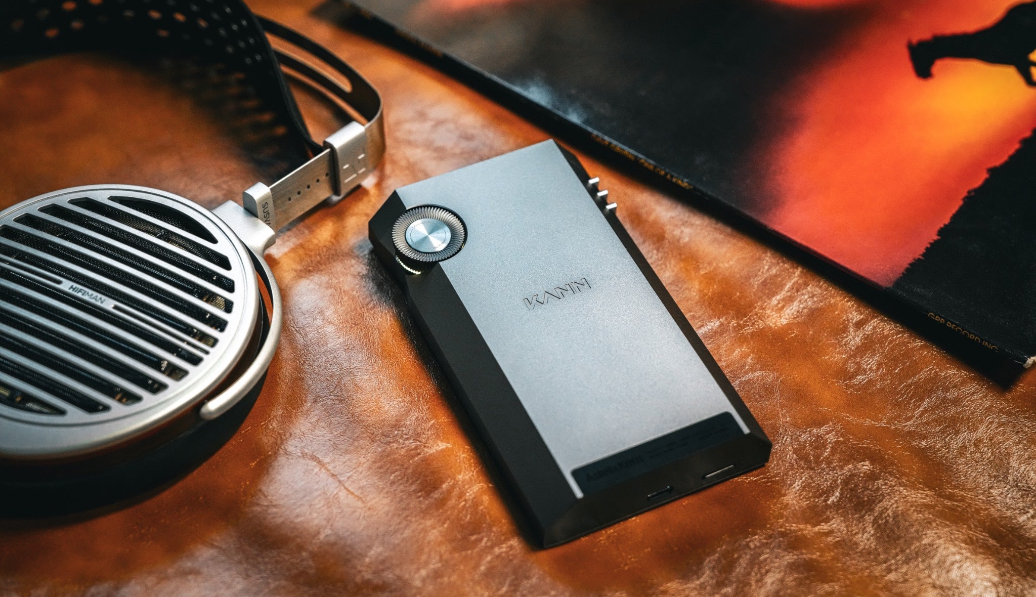 Astell&Kern KANN Ultra on leather couch with HiFiMAN Susvara headphones and vinyl jacket