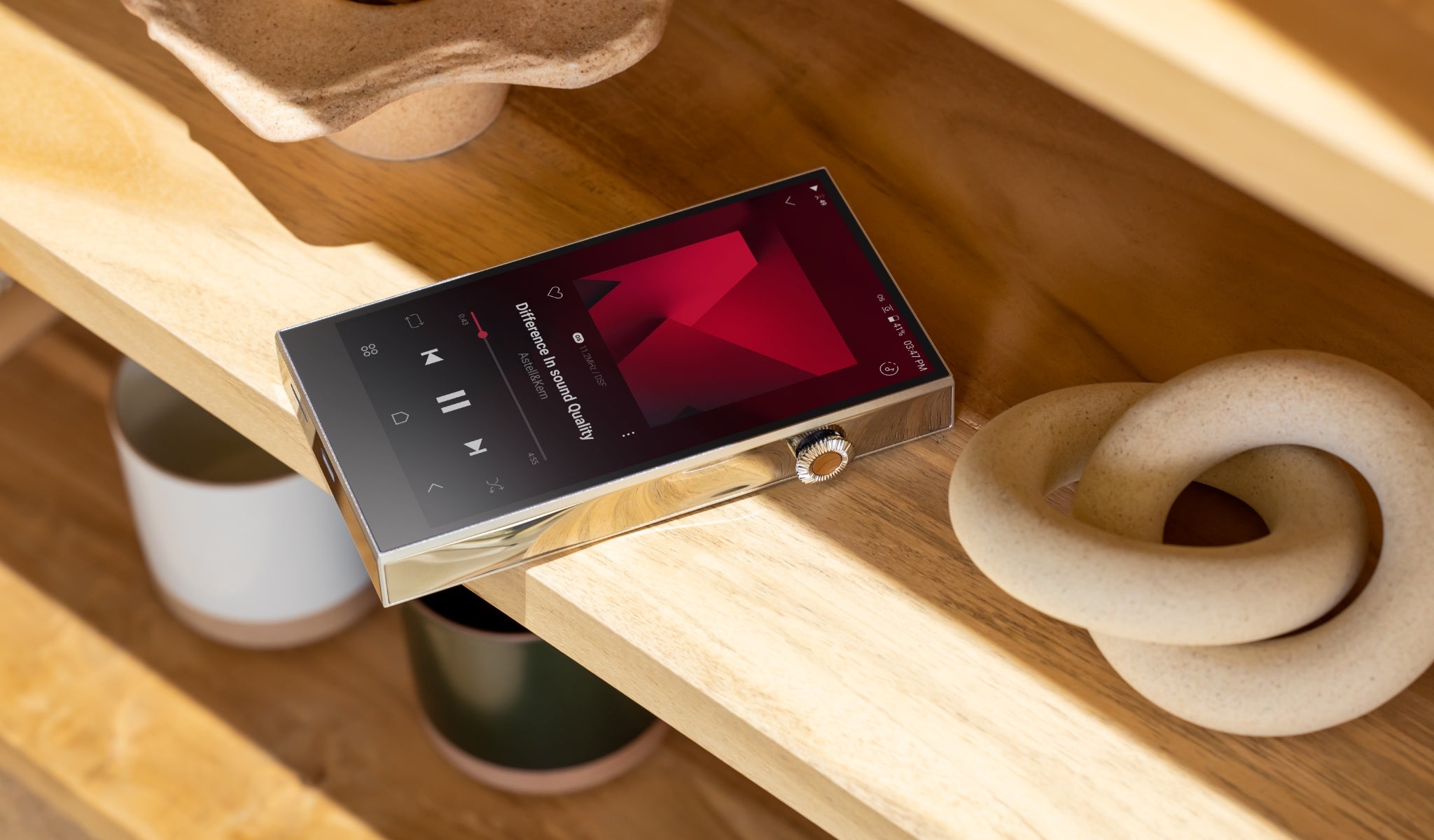 Astell&Kern SE300 on wood shelf with related decor